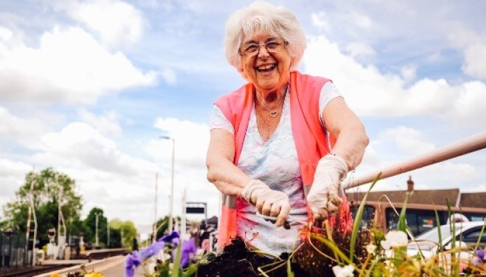 Lady gardening on Barton to Cleethorpes CRP line