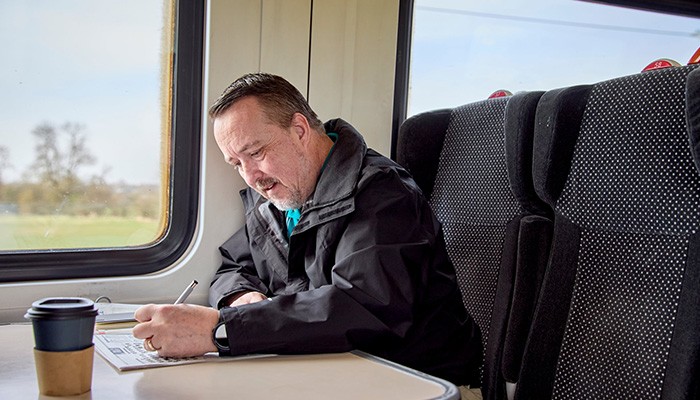 Man with a coffee on a train