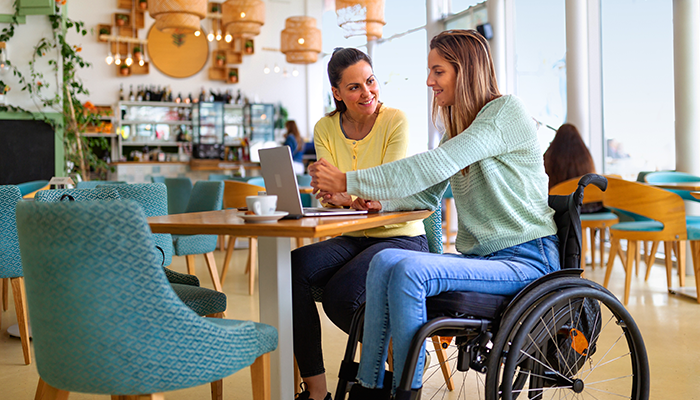 A lady in a wheelchair eating lunch