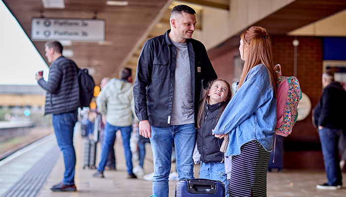 A family waiting on the train platform