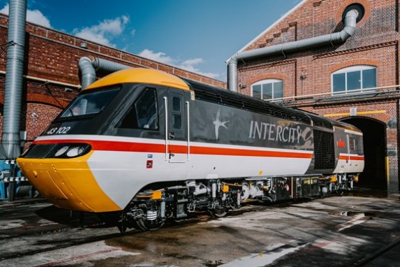 Image showing HST 43102 in original livery, freshly painted and departing the depot building. 