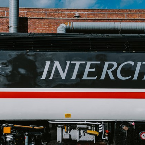 Image showing HST 43102 in original livery, freshly painted. This view shows the side of the engine, painted with the Intercity Swallow livery.